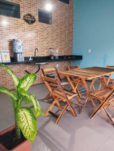 a group of tables and chairs in a room at Suíte Boa Onda Cumuruxatiba in Cumuruxatiba