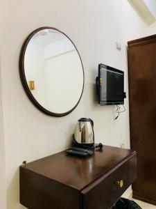 a mirror on a wall above a desk with a computer at ADRAR INSHAL Siwa - أدرار انشال سيوه in Siwa +18 photos