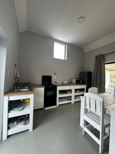 a kitchen with white cabinets and a counter top at The Sheperd's Cottage in Joubertina
