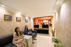 two women sitting in a waiting room at FabHotel Nanda - Nr Ludhiana Junction Railway Station in Ludhiana