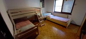 a room with two bunk beds and a window at Appartment Bezenica in Dobrova