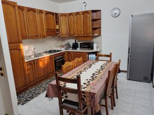 a kitchen with a table with wine bottles on it at Casa sul Naviglio in Calcio