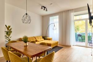 a living room with a couch and a table at Melody Apartments Vienna - Modern & Spacious with Terrace in Vienna