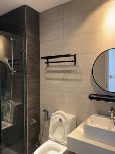 a bathroom with a toilet and a sink and a mirror at M Luna Residence in Kuala Lumpur