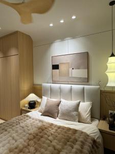 a bedroom with a large bed with white sheets and pillows at M Luna Residence in Kuala Lumpur +5 photos