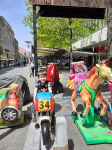 a young boy riding a toy horse on a motorcycle at Home in Kraljevo