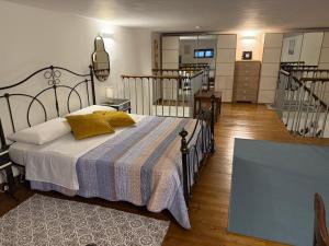 a bedroom with a bed with a striped blanket and stairs at Gloria Suite Catania in Catania