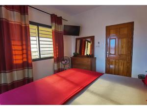 a bedroom with a bed with a red blanket on it at La MAISON BLANCHE - B - CENTRAL - CALME - WIFI - White Butterfly Hotels in Dakar +65 photos