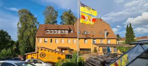 a large building with a flag in front of it at Waldhorn Dobel in Dobel