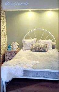 a bed with a white bedspread and pillows on it at Mary's House in Angra do Heroísmo