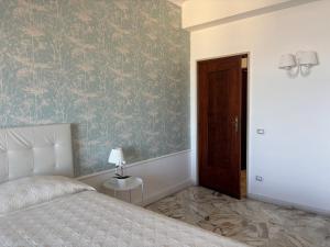 a bedroom with a bed and a brown door at Acqua Holiday House in Taranto +52 photos