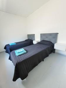two beds sitting next to each other in a room at Depto guemez 2 in General Roca