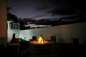 a fire pit in a yard at night at Serenity heights cosy 2BHK in Jāmb