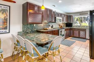a kitchen with a table and chairs in it at Family Fishing Trip! Jupiter Home with Dock, Hot Tub in Jupiter