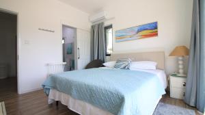 a bedroom with a bed with a blue blanket at Villa Omoris 3 bedrooms Trou aux Biches, Sea Access in Trou aux Biches +18 photos