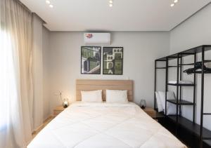 a bedroom with a large bed with white sheets at The Green Escape 4BR Villa By Travelholic in Cairo