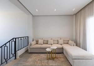 a living room with a couch and a table at The Green Escape 4BR Villa By Travelholic in Cairo