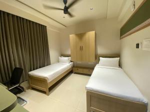 Ένα ή περισσότερα κρεβάτια σε δωμάτιο στο Sasya Elegance - A Boutique Hotel