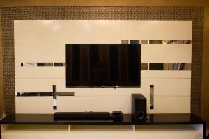 ein Flachbildfernseher, der an einer Wand hängt in der Unterkunft Sandhu farmhouse in Lahore