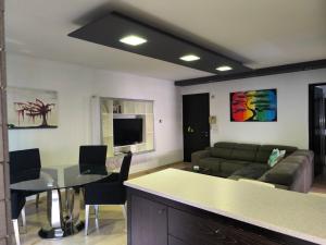 a living room with a couch and a table at Blue Tulip - Strovolos in Kato Lakatamia