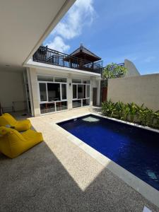 a house with a swimming pool in front of a house at Two D Villa in Ungasan