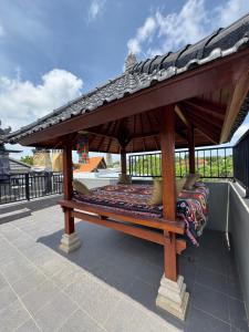 a wooden gazebo on top of a roof at Two D Villa in Ungasan