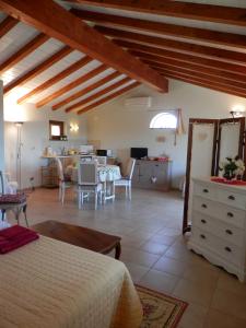 a living room with a bed and a dining room at Agriturismo La Corte - Viterbo Terme in Viterbo