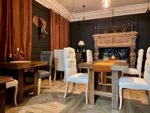 a dining room with a table and a fireplace at Chambre bleu Chic et cosy piscine spa petit déjeuner in Varennes Vauzelles