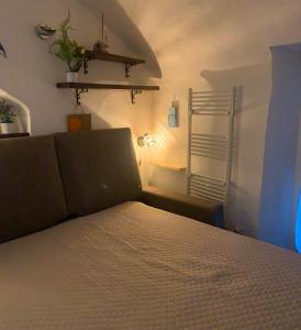 a bedroom with a bed in a room with a lamp at Casa Delfino in Sanremo
