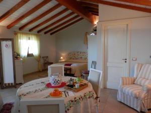 a living room with a bed and a table in a room at Agriturismo La Corte - Viterbo Terme in Viterbo