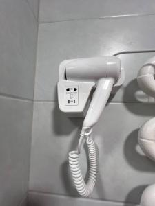 a white phone is hanging on a wall at Shahina in Samarkand