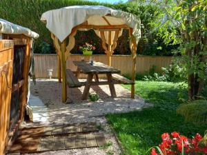 a gazebo and a picnic table in a garden at yourte d'hotes in Mailley-et-Chazelot