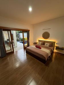 a bedroom with a large bed and a sliding glass door at Two D Villa in Ungasan +33 photos