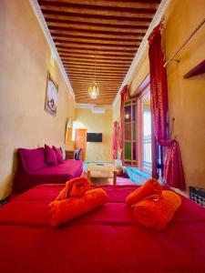 a living room with two beds and a couch at RIAD LALJ Fes in Fez