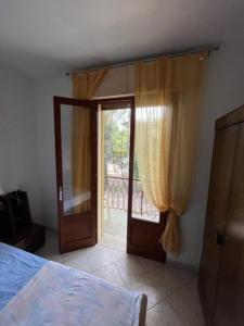 a bedroom with a door open to a balcony at Bright flat in Rosolina in Rosolina Mare +12 photos