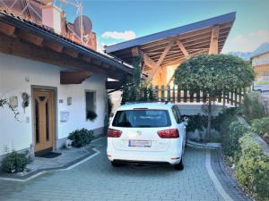 a white car parked in front of a house at Ferienhaus Dengg in Hippach