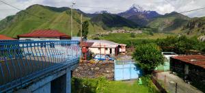 a view of a village with mountains in the background at Blue Guesthouse in Stepantsminda