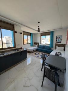 a large living room with a couch and a table at KAZA Moon Surf camp in Imsouane