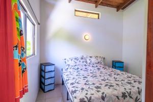 a bedroom with a bed and a window at Casa de las Palmas, Residencia Isabella in Parrita +55 photos