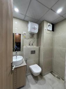 a bathroom with a toilet and a sink at Heavenly stays in Greater Noida