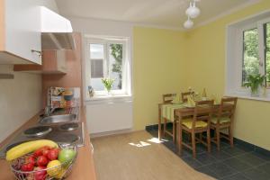 a kitchen with a table and a bowl of fruit at Haus Hillinger in Salzburg