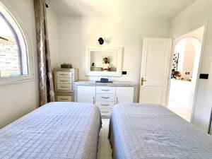 a bedroom with two beds and a mirror at Miami Beach in Mogán +8 photos