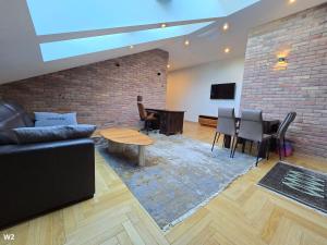 een woonkamer met een bank en een tafel bij Apartament Pałac Tryllingów in Białystok