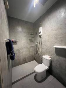 a bathroom with a shower and a toilet and a sink at The Retreat Hotel Wellness & Spa in Krabi +4 photos