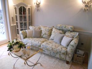 a living room with a couch and a table at Ferienwohnung Sönshörn S8M In Munkmarsch in Munkmarsch +12 photos