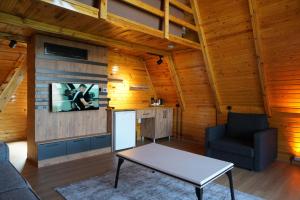 a living room with a table and a tv on a wall at Green Park Mardin Hotel 