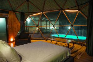 a room with a bed and a tub in a tent at Green Park Mardin Hotel 