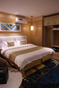 a bedroom with a large bed in a room at Wealth Hotel Ikeja in Ikeja +23 photos