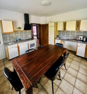 a kitchen with a wooden table and chairs at Ferienwohnungen in Lohr in Lohr +14 photos