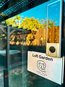 a sign on a glass door with a lot garden at Sheeps Family - Loft, Casa e Apartamento para Temporada - Praia do Rosa in Praia do Rosa